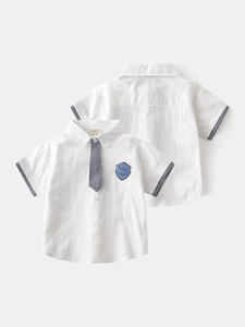 White short-sleeve boys' shirt with plaid tie and space embroidery in a flat lay view