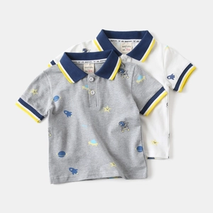 Detail of boys cotton polo shirts featuring space prints and navy collars with yellow stripes