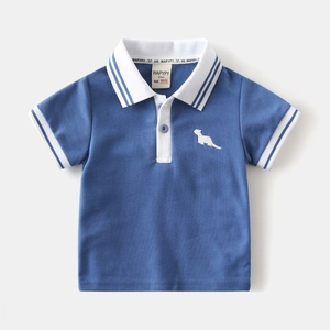Detail of blue boys' polo shirt with white collar and animal embroidery on the chest