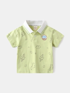 Kids short sleeve pale green dinosaur print polo shirt with white collar flat lay
