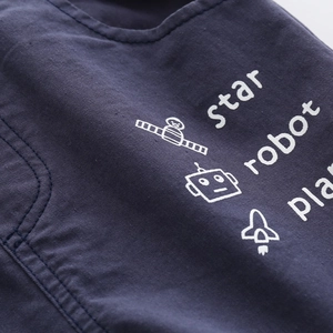 Detail of navy twill cotton fabric with white rocket and robot space theme printing