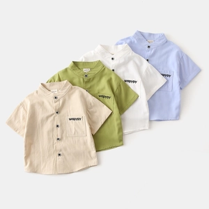 Flat lay of boys short-sleeve V-neck shirts in four colors with embroidered pockets
