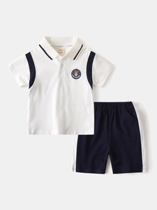 Boys white polo shirt and navy shorts set with cartoon bear patch and varsity stripes