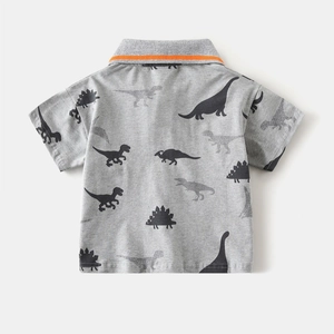 Detail of grey kids polo shirt with orange stripe collar and all-over dinosaur print
