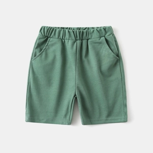 Detail of green elastic waist cotton shorts for boys with functional side pockets