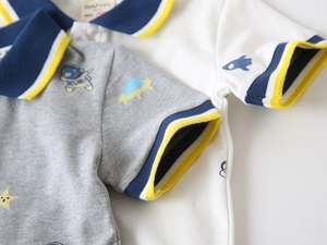 Detail of kids polo shirts with navy collar and cute space astronaut pattern prints