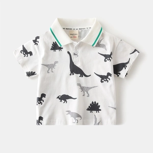 Close-up of the polo collar with green stripes and dinosaur print on cotton fabric