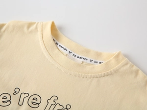 Detail of soft cream cotton t-shirt neckline with interior branded sweatband and ribbing