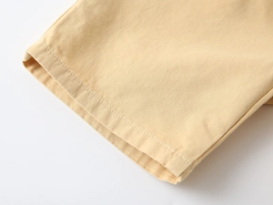 Detailed macro view of the stitching and high-quality cotton texture on kids summer shorts