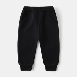 Close-up of black cotton kids jogger pants with elastic waist and ribbed cuffs for boys