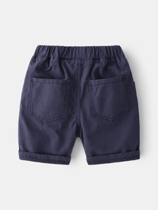 Dark blue cotton boys shorts with elastic waist and back pockets on grey background