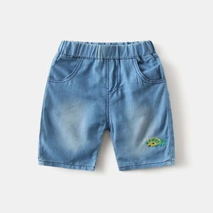 Detail view of light blue denim shorts with elastic waistband and dinosaur embroidery