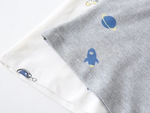 Macro detail of cotton polo shirt fabric showing space prints and fine double stitching