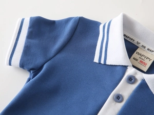 Close-up of boys polo shirt collar with contrast stripes and textured cotton fabric