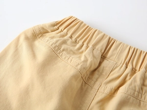 Detail of kids cotton shorts featuring elastic waistband and reinforced double stitching