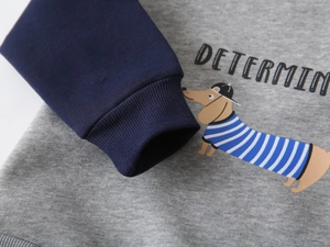 Detailed close-up of cartoon dachshund print and ribbed cuffs on kids' grey hoodie