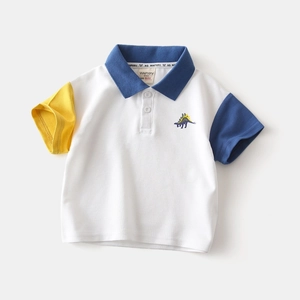 Detail of kids polo shirt featuring color-block sleeves and dinosaur embroidery