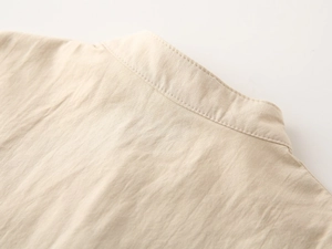 Close-up of boys' V-neck shirt showing premium linen texture and durable stitching