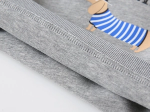 Detail of ribbed knit cuffs and cartoon dachshund print on grey cotton kid's sweatshirt