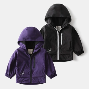 Flat lay detail of hooded windproof jackets in purple and black with dinosaur graphics