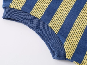 Detail view of navy and yellow striped knit fabric with elastic ribbed cuff