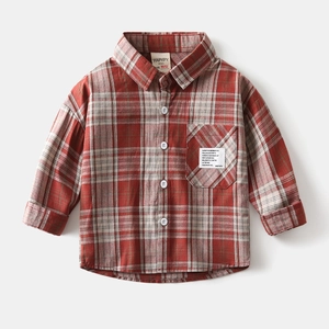 Close-up of red checkered kids shirt featuring cotton flannel texture and a brand label
