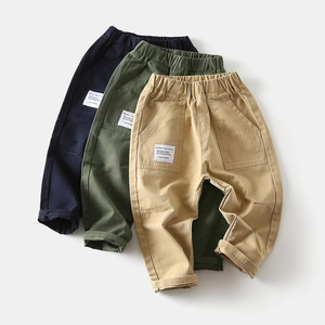 Detail of kids casual cotton pants featuring elastic waist and utility cargo pockets