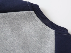 Detail of navy ribbed neckline and grey cotton knit fabric on kids sweatshirt