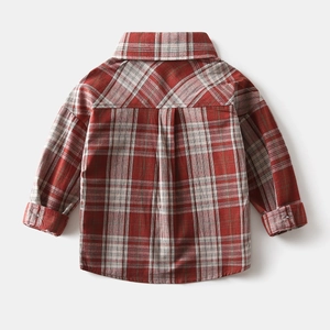 Detail view of the pleated back design on a classic red and white plaid boys' cotton shirt