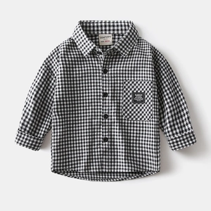 Detailed view of kids monochrome plaid shirt featuring chest pocket and fashion label