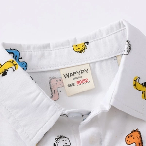 Boys white short-sleeve shirt with colorful dinosaur print and collared neckline detail