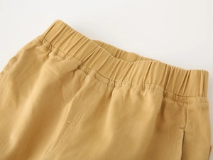 Detailed view of elastic waistband and durable twill fabric on boy's cargo pants