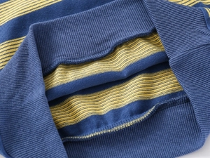 Close-up of boys' V-neck striped vest showing ribbed hem and soft knit texture detail