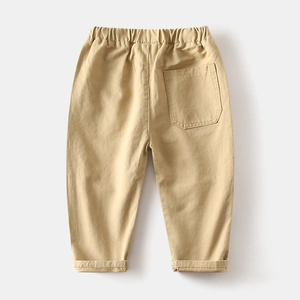Detail of khaki kids trousers featuring elastic waistband and back pocket stitching