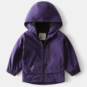 Close-up of children's purple hooded windbreaker with white dinosaur skeleton print