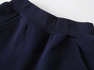 Detail of navy blue elastic waistband and pocket stitching on cotton sweatshirt set