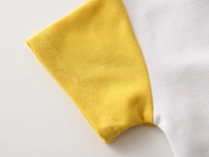 Detail of piqué cotton short sleeve cuff with durable double stitching and contrast colors
