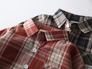 Close-up of classic red and blue plaid patterns with textured cotton fabric and woven labels