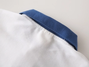 Close-up of white cotton polo shirt collar with blue ribbed trim and neat stitching