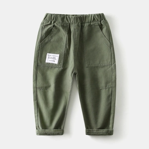Detail of kids cargo pants showing elastic waistband and large side pockets in olive green