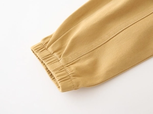 Detail shot of boys' cargo pants showing elastic ribbed cuffs and yellow twill fabric