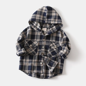 Detail of classic plaid kids' hooded shirt featuring wooden buttons and front pockets