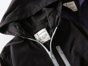 Detail of children's hooded jacket featuring windproof fabric and warm fleece lining