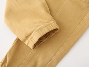 Detail of elastic cuffs on boys' cargo pants in premium khaki twill cotton fabric