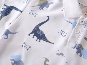 Detail of kids polo shirt showing breathable pique fabric and cute dinosaur print