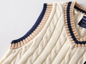 Detailed cable knit pattern on children's cream V-neck vest with striped ribbed trims