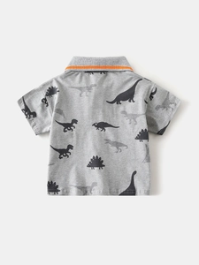 Grey kids polo shirt with all-over dinosaur print and orange collar tipping detail