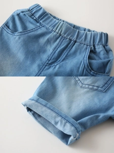 Light blue denim shorts for boys with elastic waist and stylish rolled cuffs on white background