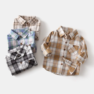 Detailed view of kids plaid flannel shirts showing classic collar and wooden button details