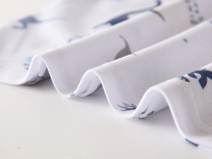 Breathable bird-eye mesh fabric detail with blue cartoon dinosaur prints on white polo shirt